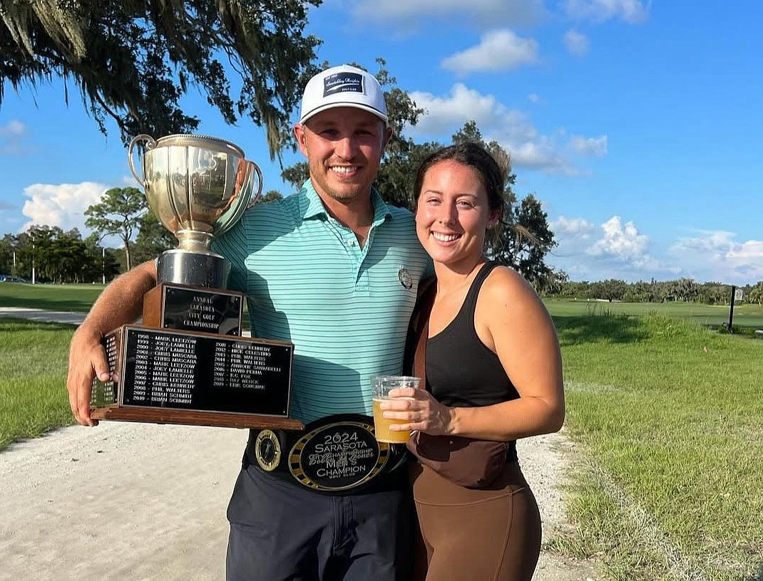 2024 Sarasota City Championship winner Brad Knight and his girlfriend, Paige Reichenberger, pose with the trophy after winning the 49th annual event at Bobby Jones Golf Club.