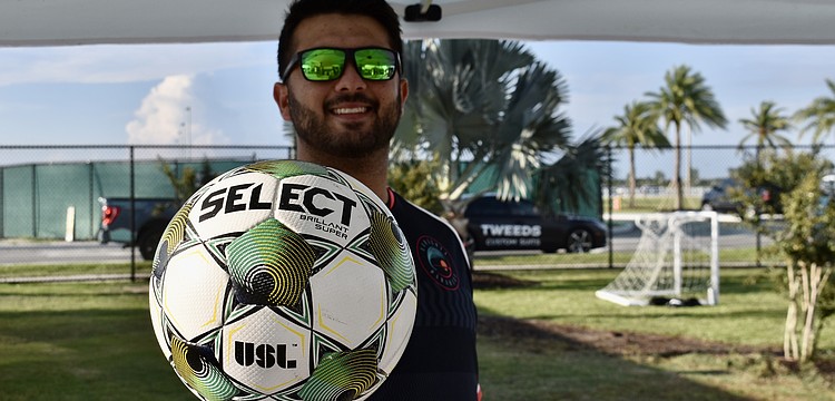 Adam Altman, account executive for the Sarasota Paradise, greets guests at the Premier Sports Campus Aug. 19 for Sarasota Paradise Day.