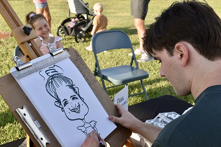 Andrew Sapienza draws a caricature of 7-year-old Gia Di Meo.