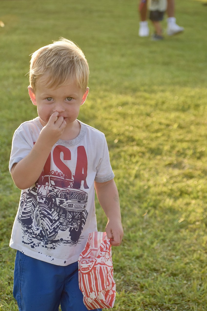 Bradenton's Damon Haines, 3, can't get enough of the popcorn.