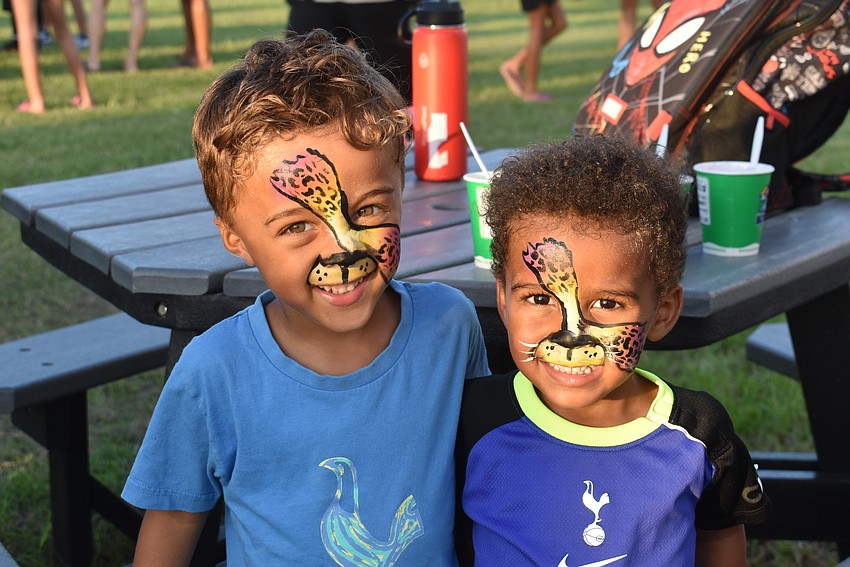 Palmetto's Demetri Murray, 3, and Tristan Murray, 2, can't stop smiling after having their faces painted.