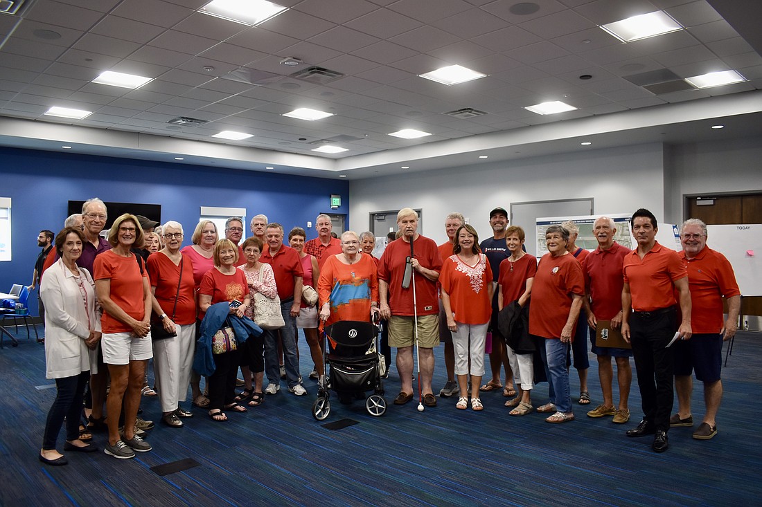 Residents of Country Club East wear red shirts to oppose the Little League fields planned for the park.