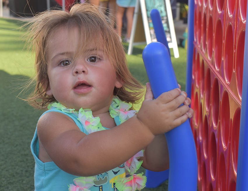 Sarasota's Ocean Blue Hall, 16 months, loves the water and is eager to play games with his dad Jeff Hall.