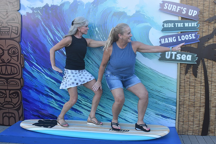 Sarasota's Roxanne Schwans and Lisa Vaccaro catch a wave at the night market on Aug. 21.