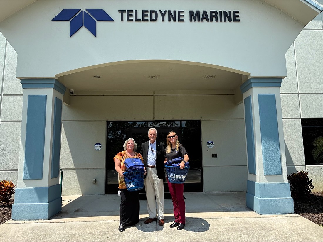 Teledyne Marine employees make a donation for shelter comfort initiatives by Volusia Community Organizations Active in Disasters. Courtesy photo