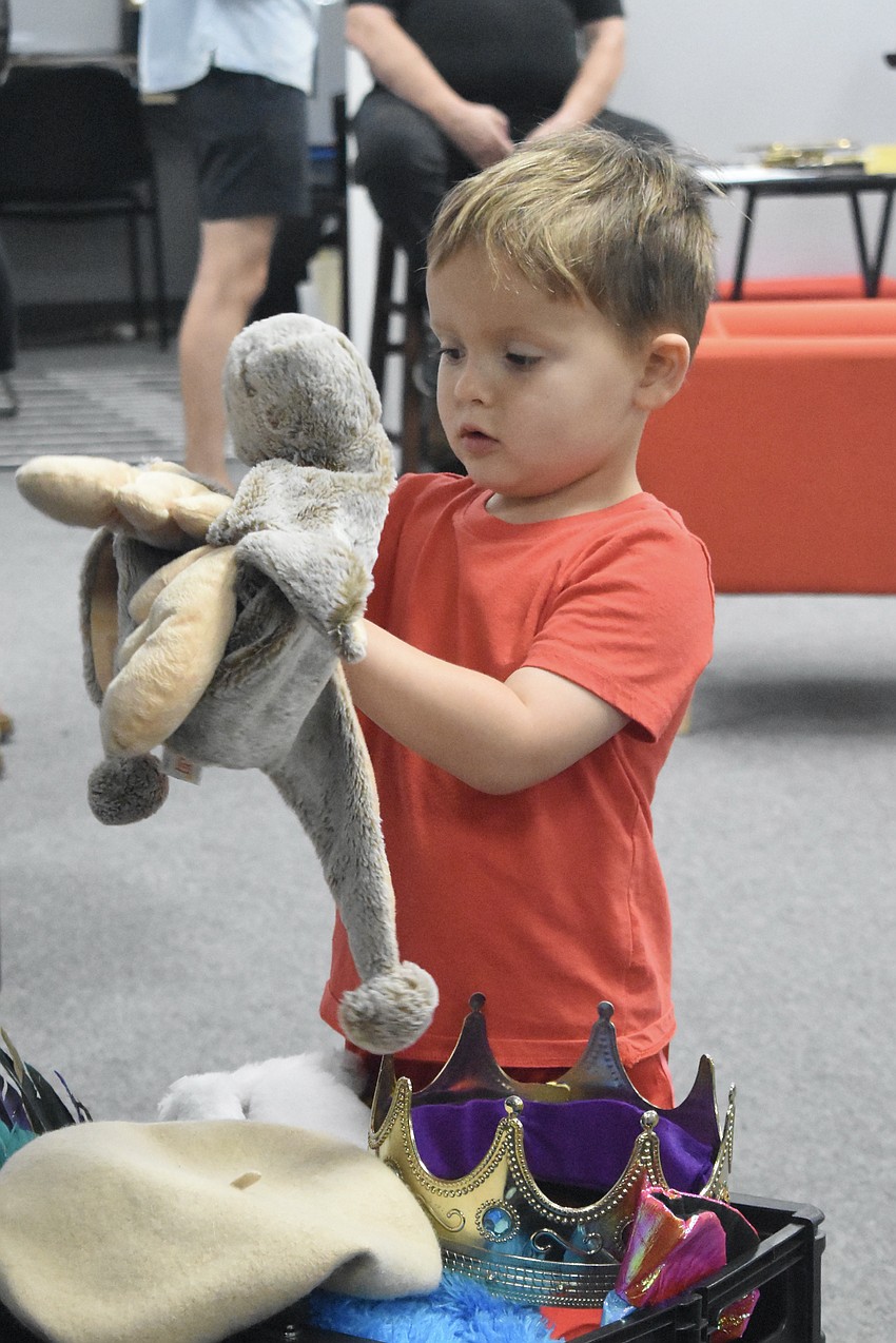 Leo Stuart, 4, plays with the props at the Drama Kids International station.