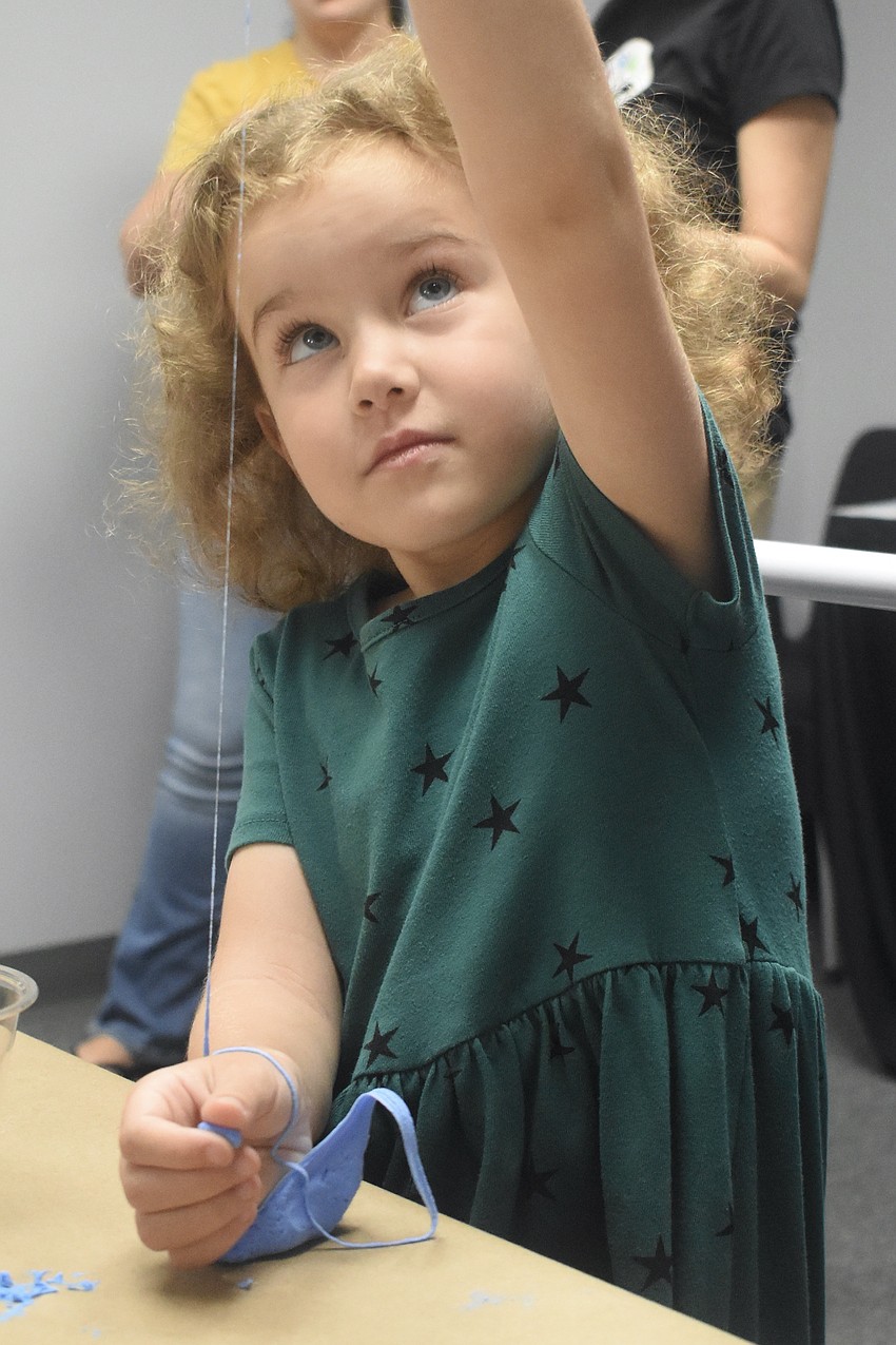 Nora Roux, 5, performs an art experiment with Children's Art Classes.