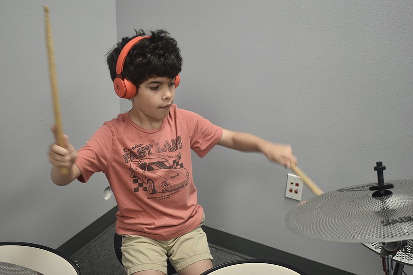 Jonah Eiseman, 7, plays the drums.