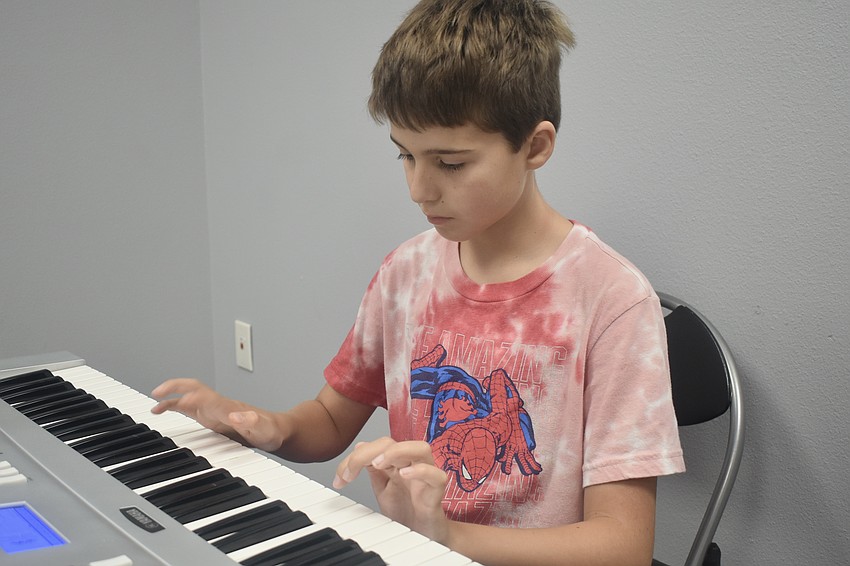 Graham Harrison, 10, plays the keyboard.