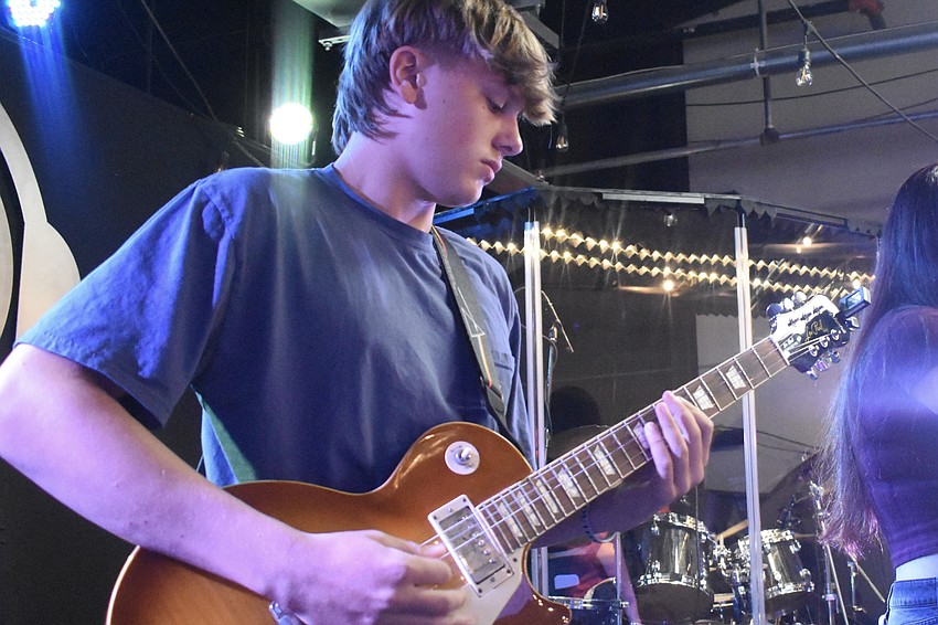 Music Compound band member Evan Archambeau, 16, performs as Solar Apocalypse takes the stage.
