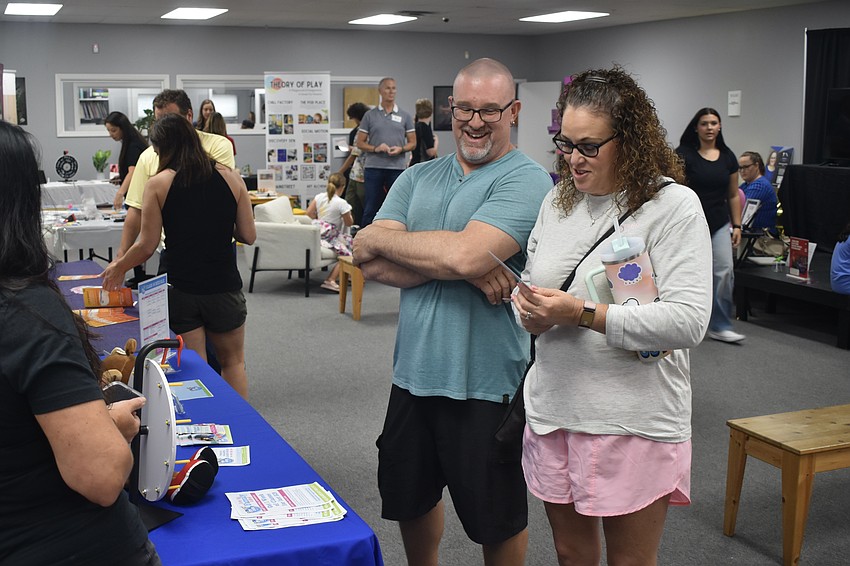 Michael Baldini and his wife Heather Baldini talk with My Gym Sarasota owner Angela Delo.