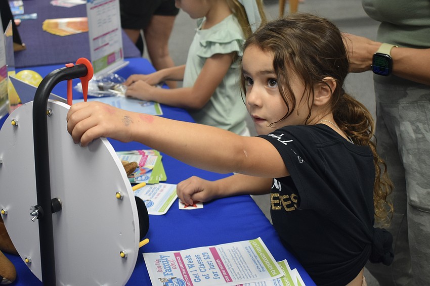 Fiona Krick, 5, spins the wheel at My Gym Sarasota.