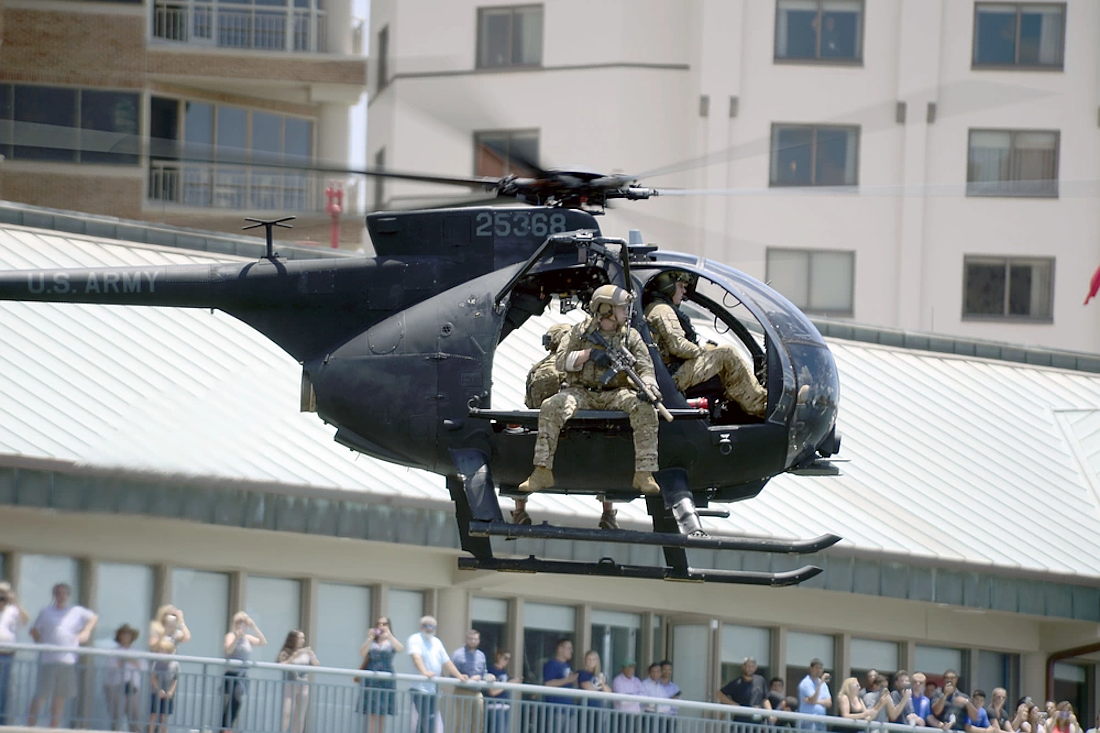Multinational special operations forces ride in an Mh-6 helicopter during a demonstration for the 2018 International Special Operations Forces week in downtown Tampa.