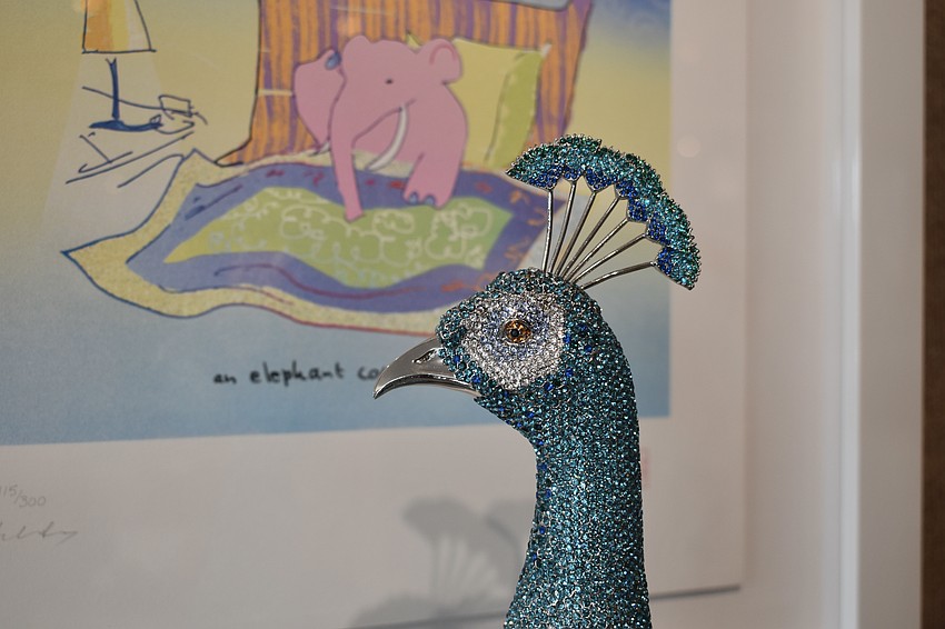 A peacock made of Swarovski crystals is displayed in the gallery.