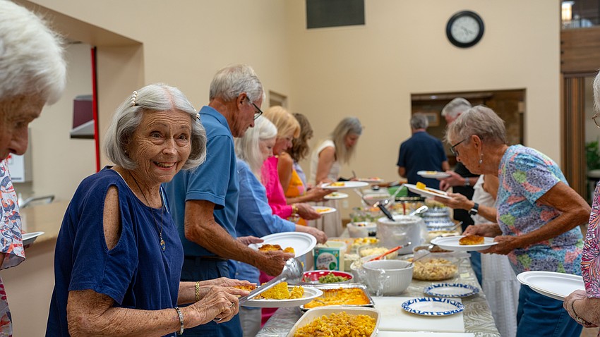 Eleanor McConnell fixes her plate at Christ Church of Longboat Key's annual fish fry at the church Thursday, Aug. 27.