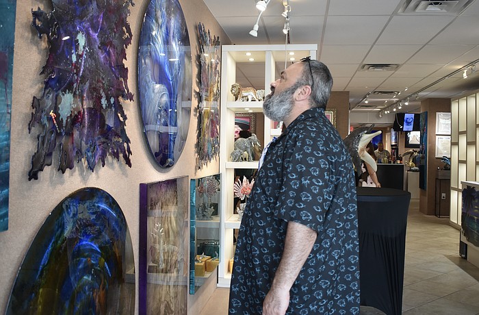 Ramin Mesghali looks at the artwork.