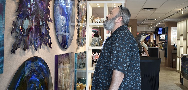 Ramin Mesghali looks at the artwork.