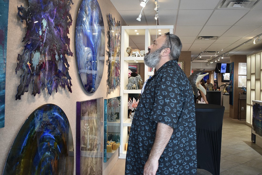 Ramin Mesghali looks at the artwork.