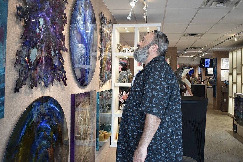 Ramin Mesghali looks at the artwork.