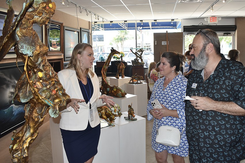 Grace Kerlin of Wyland Galleries talks with Longboat Key Chamber president Kim Verreault and Ramin Mesghali.
