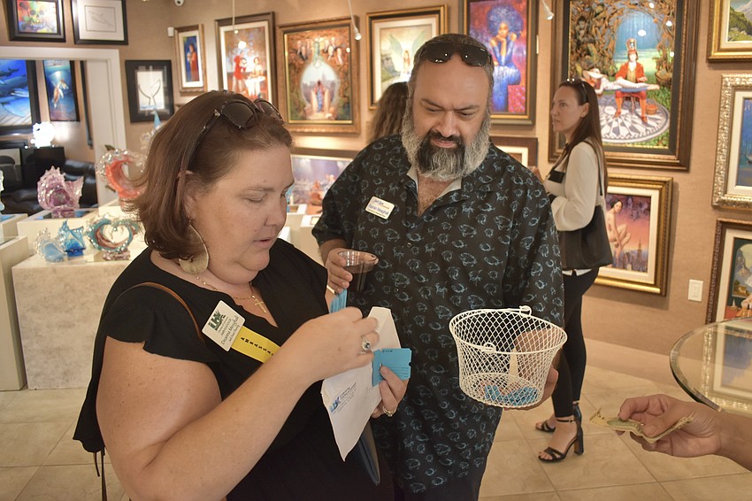 Deanna Mesghali and her husband Ramin Mesghali prepare raffle tickets.