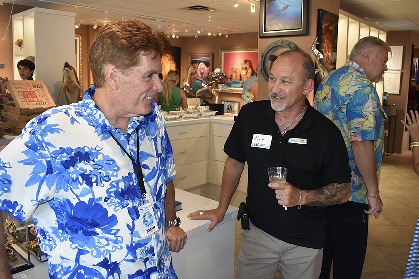 Brian Hallam of Wyland Galleries talks with Kevin Henault.