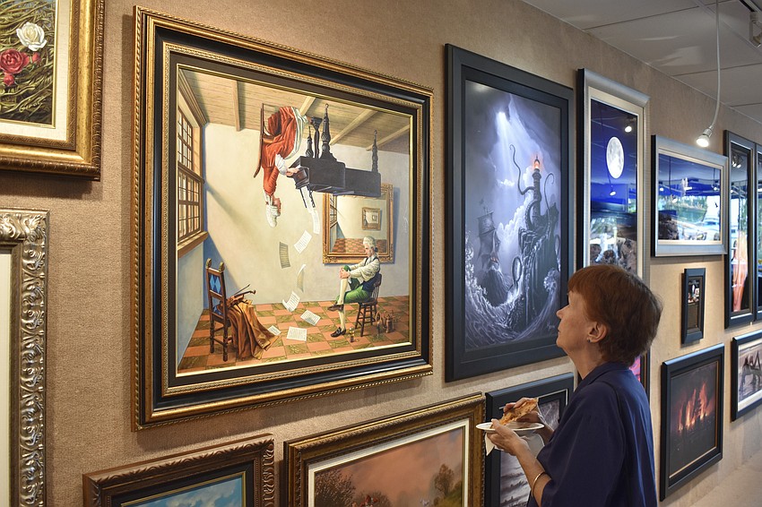 Nancy Taussig looks at the artwork.