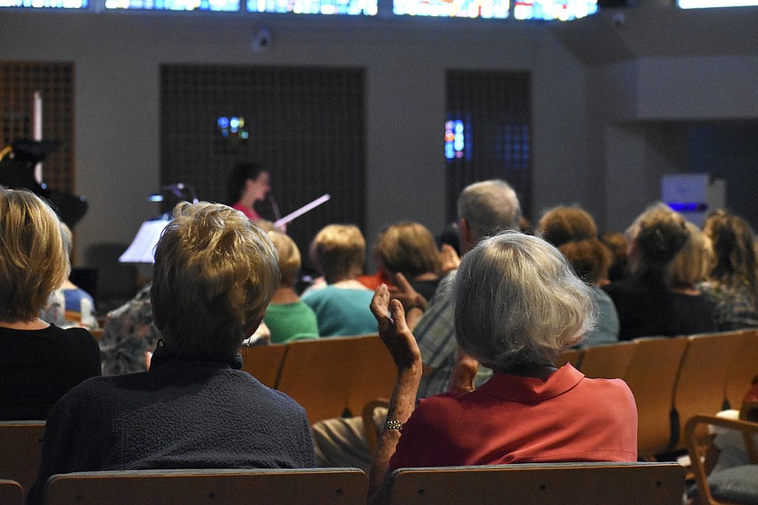Attendees Linda Kenner and Jane Whittlinger applaud the performance.