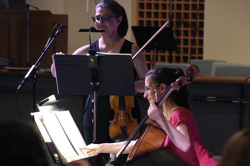 Milene Moreira and Nadine Trudel turn the page to the next piece.
