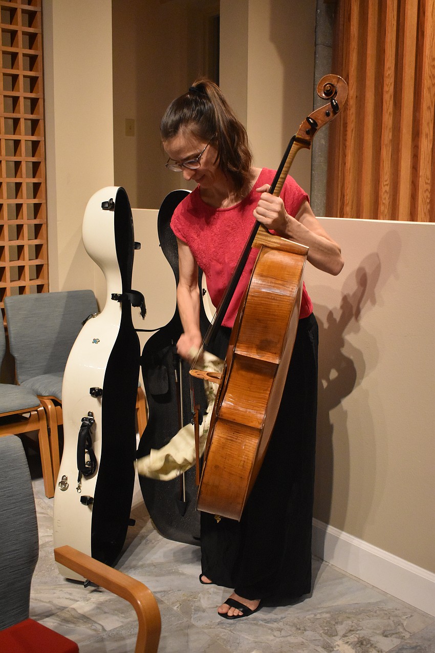 Nadine Trudel packs away her cello, an antique from the year 1770, made by Joseph Hill.