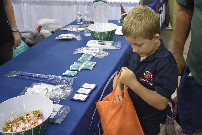 Liam Middleton, 7 bags some candy at the Millenium Physician Group table.