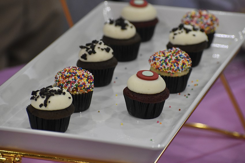 Treats by Sprinkles Cupcakes are set out for guests.