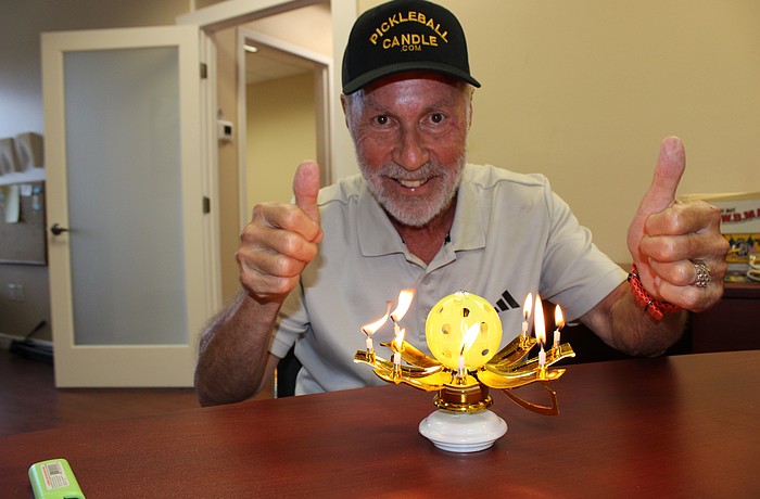 When Stanley Brown's Pickleball Musical Birthday Candle is lit, its sides spin and drop to reveal a pickleball and candles.