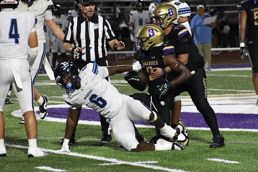 Senior Tony Bland of Berkeley Prep, and senior Tyren Wortham and junior Nate Rodriguez of Booker High School, play on the field.