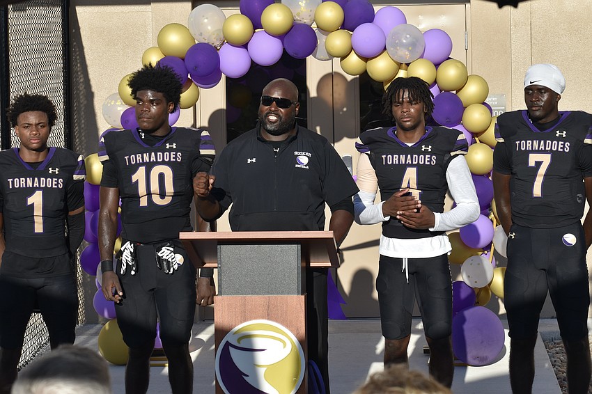 Senior Dylan Wester, senior Kevontay Hugan, coach Carlos Woods, senior ___________ and senior Joel Morris take to the podium for the opening of the field house.