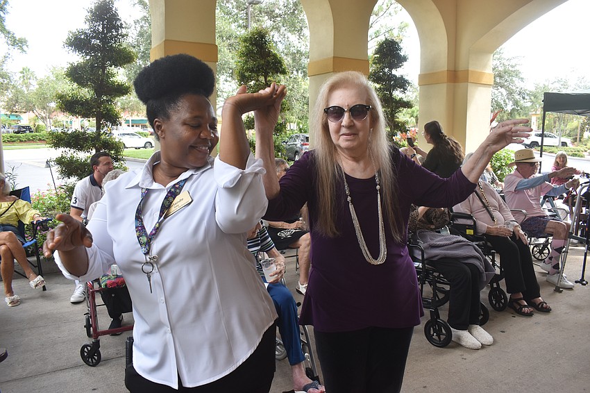 Medication technician Mirlande Gay shares a dance with Sharlette Rackers, who is known to get up and dance at events.