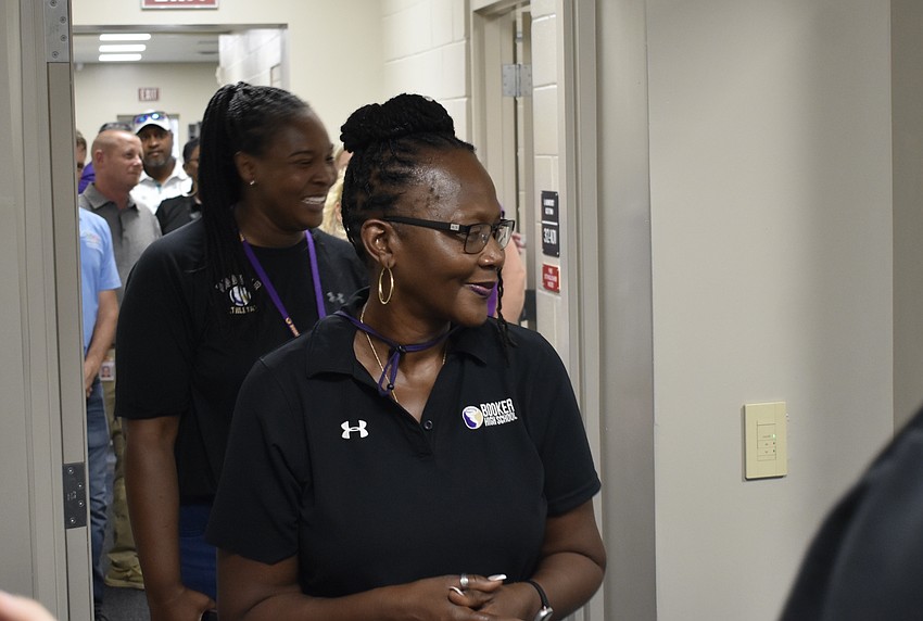 Assistant Athletic Director Angie Byrd and Principal Rachel Shelley walk through the field house.