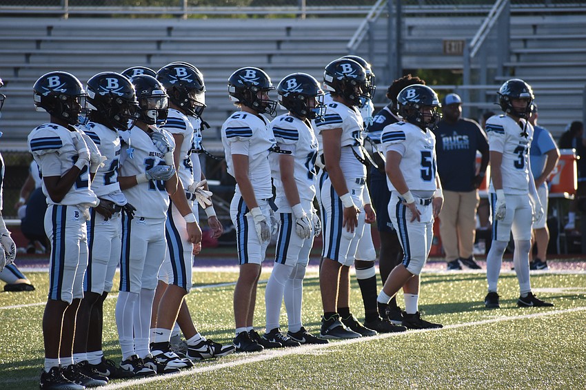 Athletes from Berkeley Prep line up on the field.