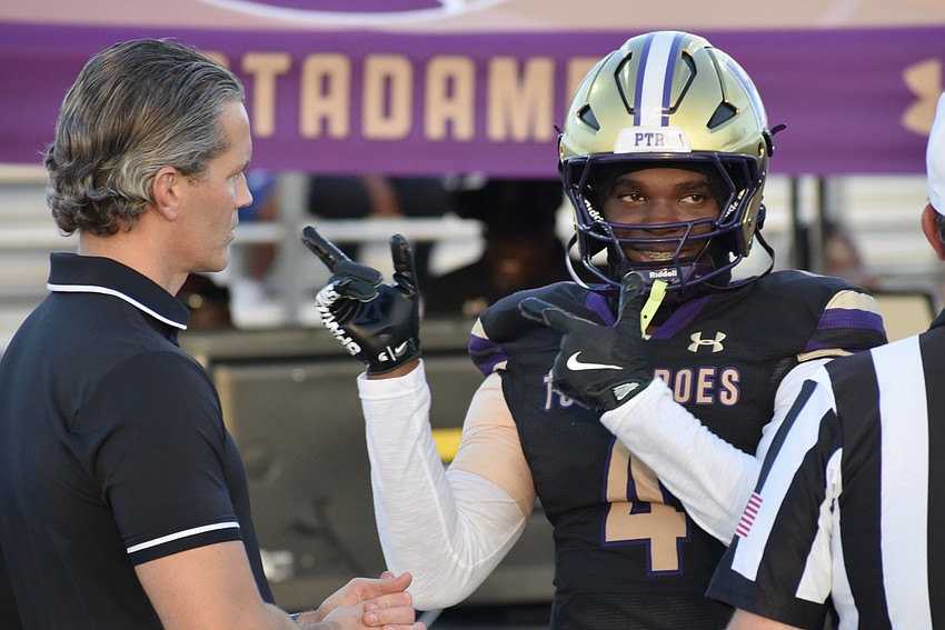 Superintendent of Schools Terry Connor approaches junior Augis Blanc