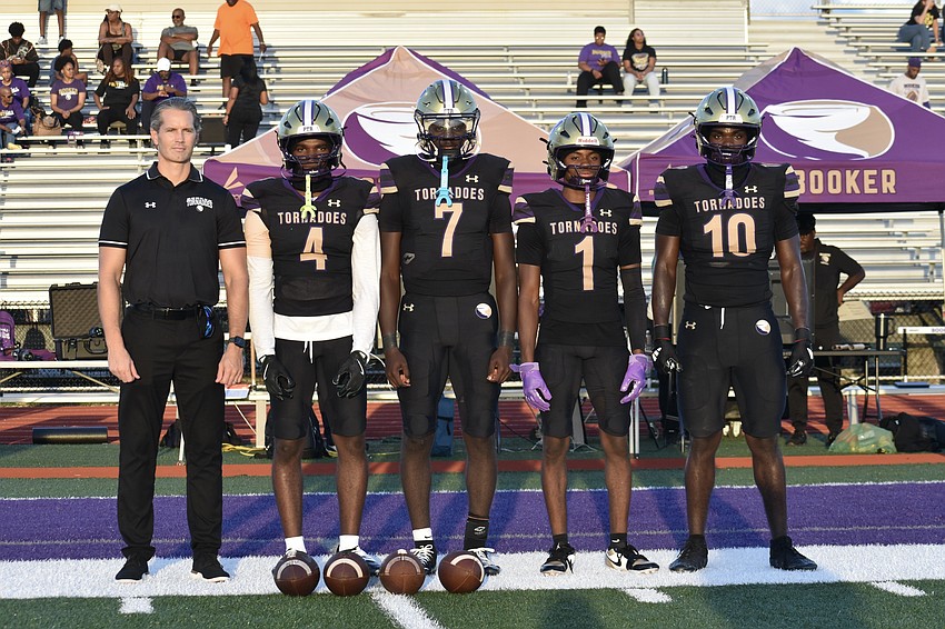Superintendent of Schools Terry Connor poses with seniors Karaijus Hayes, Joel Morris, Dylan Wester and Kevontay Hugan.