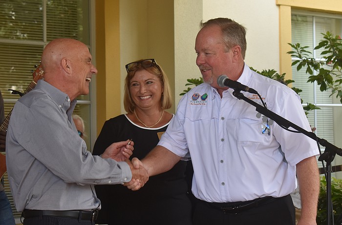 Residence director Ramsey Jennings and sales director Sandra Barkey welcome City of Bradenton mayor Gene Brown to the The Windsor of Lakewood Ranch 20th anniversary celebration.