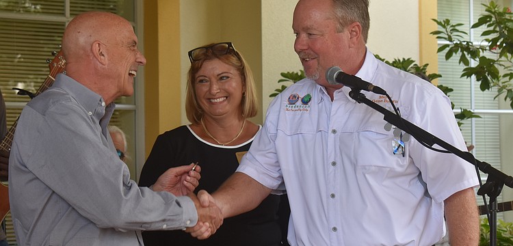 Residence director Ramsey Jennings and sales director Sandra Barkey welcome City of Bradenton mayor Gene Brown to the The Windsor of Lakewood Ranch 20th anniversary celebration.