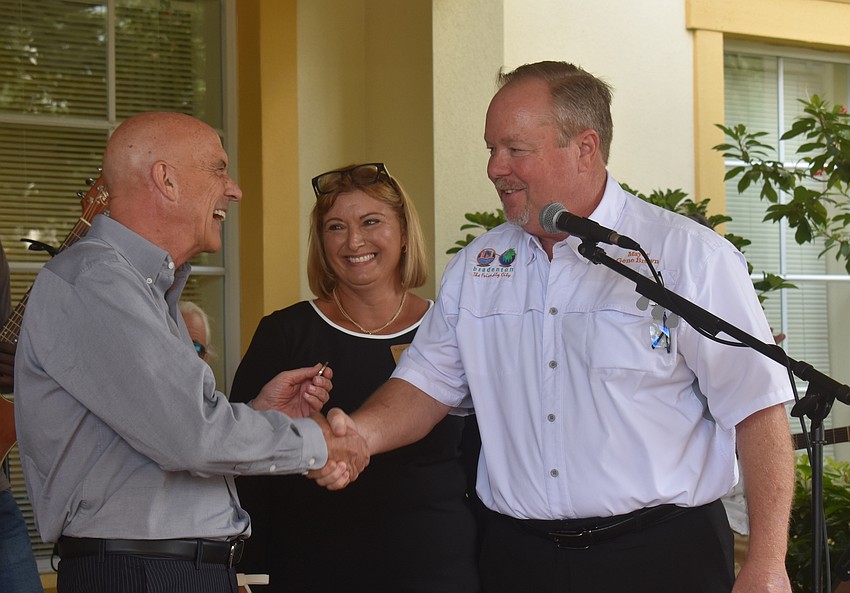 Residence director Ramsey Jennings and sales director Sandra Barkey welcome City of Bradenton mayor Gene Brown to the The Windsor of Lakewood Ranch 20th anniversary celebration.