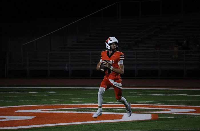 Sarasota junior quarterback Hudson West eyes the field before attempting a pass against Braden River.