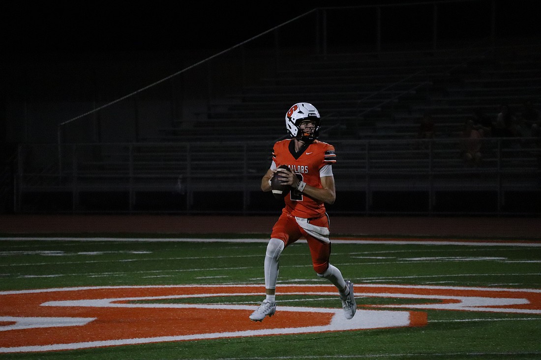 Sarasota junior quarterback Hudson West eyes the field before attempting a pass against Braden River.
