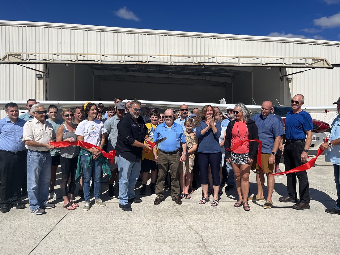 Teens-In-Flight  President Ricky Carson "Ric" Lehman, 69, unexpectedly died on Thursday, Aug. 22. Lehman (center, left) is pictured here at the ribbon cutting ceremony for Teens-In-Flight's new hanger in 2022. Courtesy photo