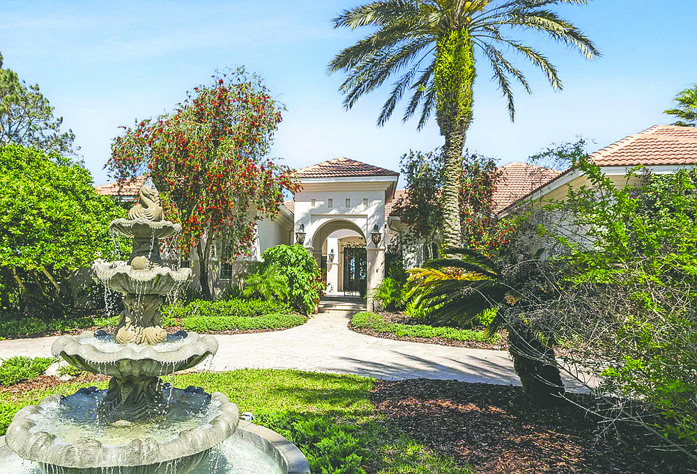 Marshfront single-story Spanish-style home features four bedrooms, five bathrooms, wine cellar, screened pool, porches, patio and dock.