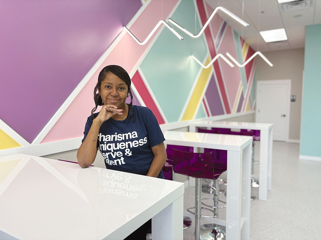 Danielle McQueen, owner of the Springfield Scoops and Scoops Lounge ice cream shops, sits in the Scoops Lounge location in North Jacksonville. She says “We’re not just about making money. It’s about enhancing the communities around us.”