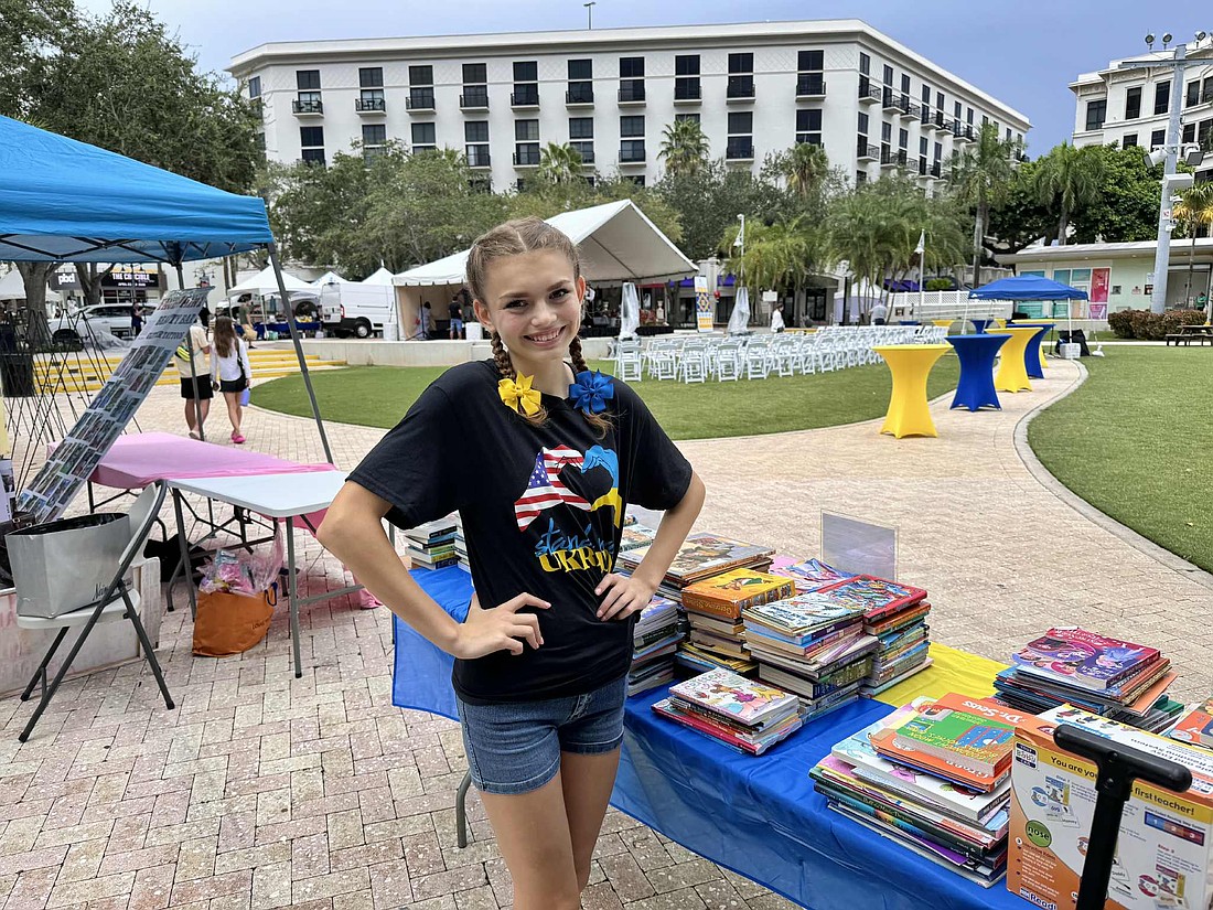 Mia Wojcik happily distributed books at the Ukrainian Cultural Festival.