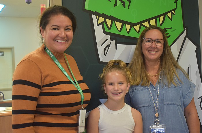 B.D. Gullett Elementary front desk clerk and parent Cristina Holland, student Brooke Green and Principal Julie Gierhart are ready to take on the school year with fewer bodies in the school.